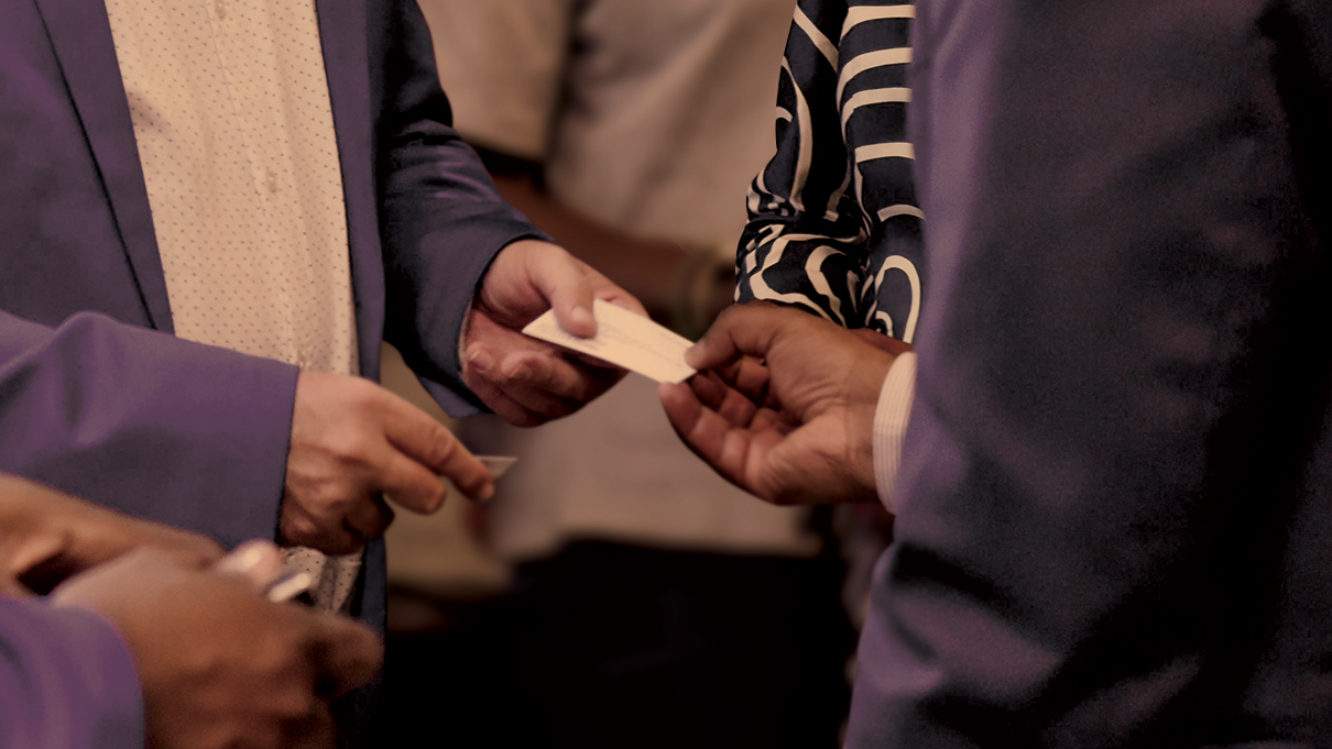 a group of people holding papers