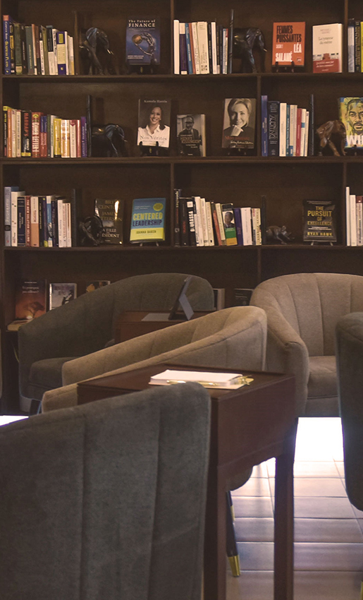 a chair in front of a bookshelf with books on it