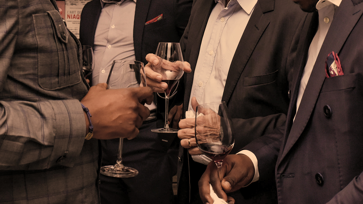 a group of people holding wine glasses